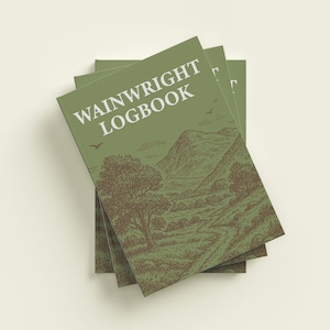 May include: A pile of green "Wainwright Logbook" journals. The cover of each journal displays a brown landscape illustration with mountains, trees, and a path. The title is in white, and the design evokes a vintage travel guide.