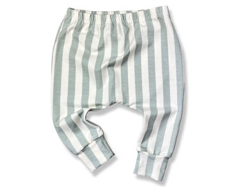 May include: Gray and white striped baby pants with a cuffed bottom.