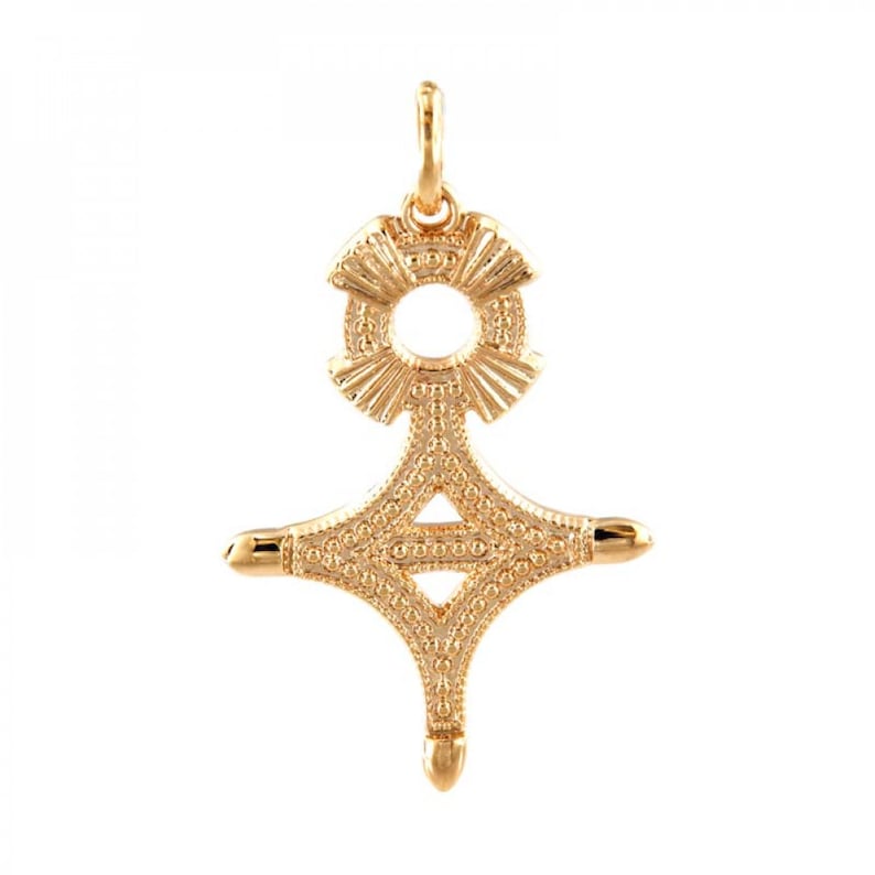 May include: A gold pendant in the shape of a cross with a circle at the top. The cross is decorated with a textured pattern.