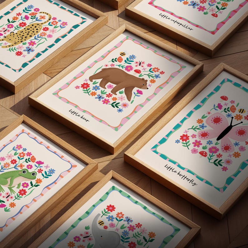 May include: A collection of framed art prints featuring colorful illustrations of animals and insects, including a cheetah, bear, frog, butterfly, and elephant. Each print has a floral border and the name of the animal. The frames are made of wood.