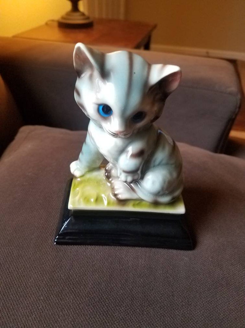 Blue Grey and Beige Stripe Cat on Platform with Pink Ears Blue Grey and Beige Stripe Cat on Platform with Pink Ears