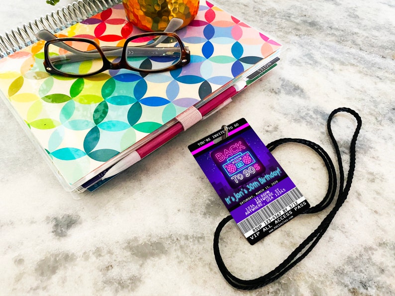 May include: A purple and neon pink party invitation in the shape of a 90s style ID badge with a black lanyard. The text reads "Back to 90s It's Jon's 30th Birthday!" with a date and time. The invitation also includes a ticket stub with the text "RSVP 123-4567 by 3/12 VIP All Access Pass".