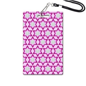 May include: A pink and white patterned lanyard with a star of David design. The lanyard has a silver clip and a black strap.