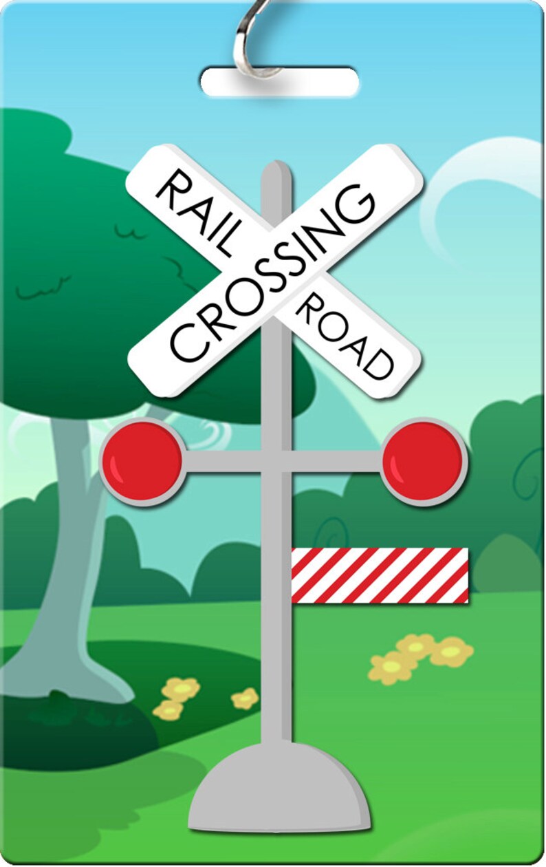 May include: A white and red railroad crossing sign with the words "RAIL CROSSING ROAD" on it. The sign is attached to a gray pole with red lights on either side and a red and white striped barrier.
