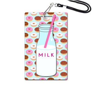 May include: A blue and white ID badge with a milk bottle and pink straw on a background of pink and brown donuts. The milk bottle has the word "MILK" printed on it.