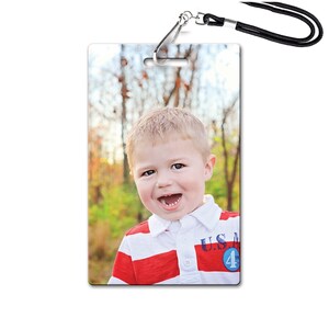 May include: A photo ID card with a photo of a young boy smiling. He is wearing a red and white striped shirt with a blue and white patch that says "U.S. 4m".