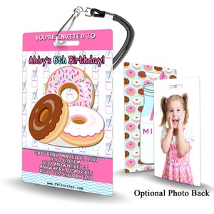 May include: Pink and blue birthday party invitation with a donut theme. The invitation features a donut with sprinkles, a chocolate donut, and a plain donut. The text on the invitation reads "You're Invited to Abby's 6th Birthday!" and includes the date, time, and location of the party.