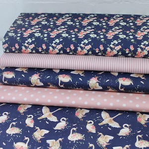 May include: A stack of five fabric swatches featuring different patterns. The top swatch is a dark blue fabric with a white and pink floral print. The second swatch is a pink and white striped fabric. The third swatch is a dark blue fabric with a white swan print. The fourth swatch is a pink fabric with white polka dots. The bottom swatch is a dark blue fabric with a white swan print.
