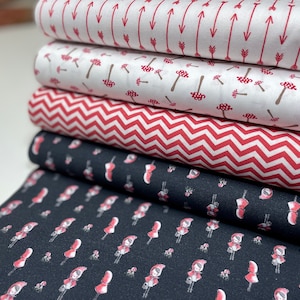 Könnte beinhalten: Ein Stapel aus fünf Stoffrollen mit verschiedenen Mustern. Die unterste Rolle hat einen schwarzen Hintergrund mit einem sich wiederholenden Muster aus roten, mit Kapuzen versehenen Figuren. Die nächste Rolle hat ein rotes und weißes Zickzackmuster. Die dritte Rolle hat einen weißen Hintergrund mit einem sich wiederholenden Muster aus roten Pilzen. Die vierte Rolle hat einen weißen Hintergrund mit einem sich wiederholenden Muster aus roten Pfeilen. Die oberste Rolle hat einen weißen Hintergrund mit einem sich wiederholenden Muster aus roten Pfeilen.