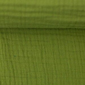 Peut inclure: Gros plan sur un tissu vert avec un motif textur&eacute; en forme de gaufre. Le tissu est doux et a un aspect l&eacute;g&egrave;rement froiss&eacute;.