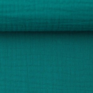 Peut inclure: Gros plan sur un tissu bleu sarcelle avec un motif tiss&eacute; textur&eacute;.