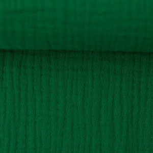 Peut inclure: Gros plan sur un tissu vert fonc&eacute; avec un motif textur&eacute; et tiss&eacute;.