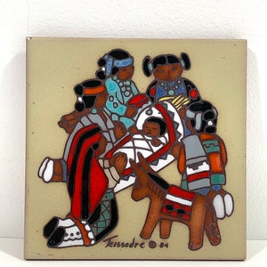 May include: Square ceramic tile with a Native American themed design. The tile features figures in traditional clothing, a baby, and a donkey. The tile is tan with red, black, blue, and brown accents. The artist's signature and the year '84 are visible.