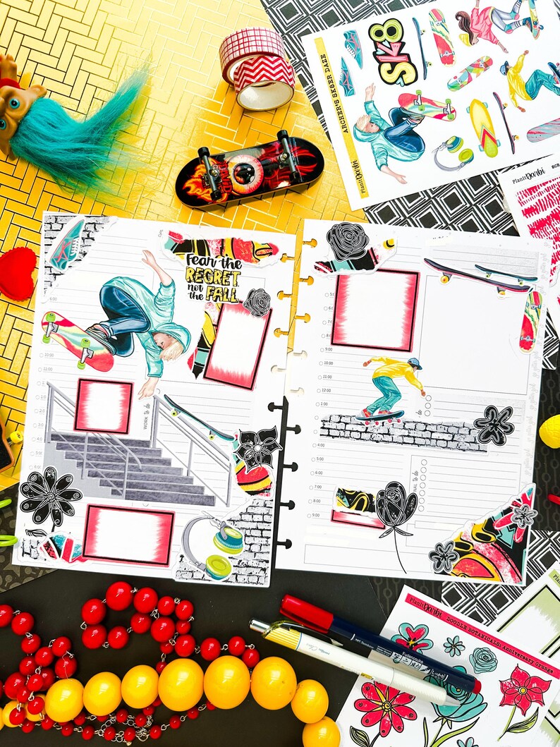 May include: A colorful planner with a skateboard theme. The planner has a black and white checkered background with a variety of stickers, including a skateboarder, a skateboard, and a flower. The planner also has a section for writing notes and a section for scheduling appointments. The text "Fear the regret not the fall" is visible on the planner.