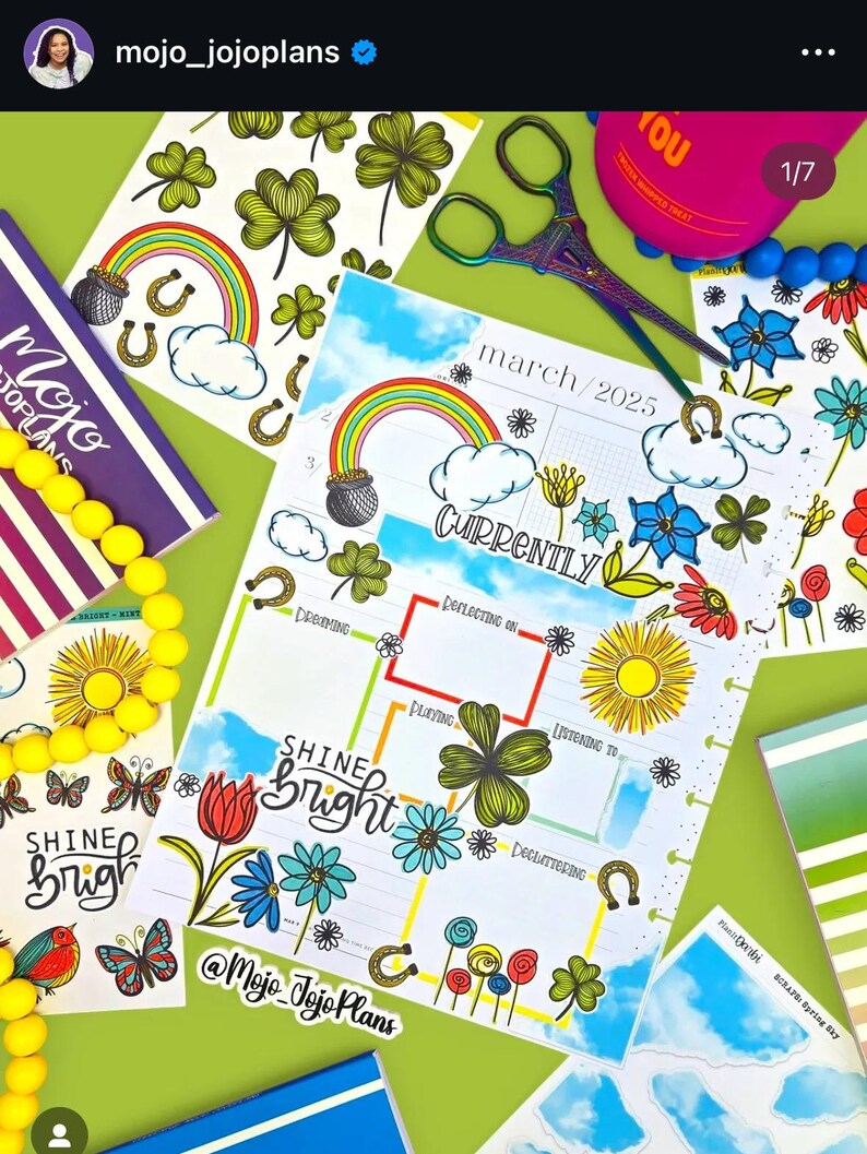 May include: A colorful planner with a March 2025 calendar page, decorated with stickers featuring rainbows, shamrocks, flowers, and a pot of gold. The planner has a section labeled "Currently" with boxes for "Dreaming", "Reflecting on", "Playing", "Listening to", and "Decluttering". The planner also has a sticker that says "Shine Bright".