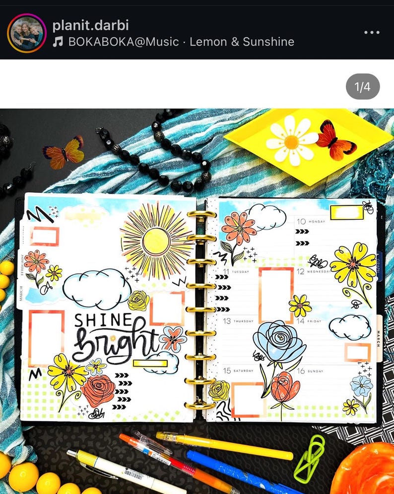 May include: A weekly planner with a bright yellow sun, clouds, and flowers drawn on the pages. The text "Shine Bright" is written in black marker on the left page. The planner is open to the week of March 10th.