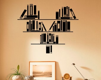 May include: Black and white wall decal of bookshelves filled with books, shaped like a heart. The decal is on a beige wall.