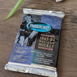 May include: A set of three ceramic mugs with a speckled, matte finish in cream, light grey, and dark grey. Each mug has a simple, modern design and a rounded handle.