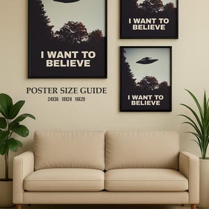 May include: Three framed posters with the text "I Want To Believe" and a silhouette of a UFO. The posters are displayed on a wall above a beige sofa. The poster sizes are listed below the largest poster: 24x36, 18x24, 16x20.