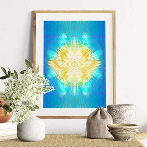 May include: Framed art print featuring a vibrant, abstract design with a central eye symbol, wings, and radiating light. The artwork is predominantly blue and yellow, with the text "empath designs" at the bottom. The print is displayed on a light-colored wooden frame.