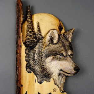 May include: A carved wooden wolf head sculpture on a wood background. The wolf is looking to the right and has a detailed fur texture. The sculpture is signed "Davydov Art" and "www.davydovart.com".