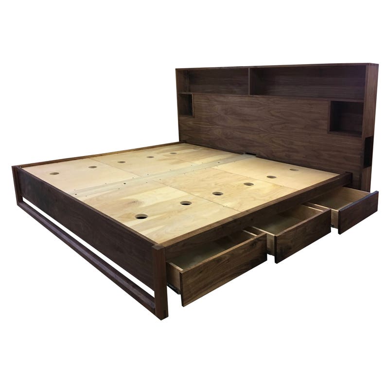 May include: A dark brown wooden bed frame with a headboard that has built-in shelves. The bed has three drawers that pull out from the bottom.