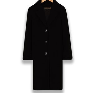 May include: A black long-sleeved coat with a button closure and a label that reads "Kristen Blake".