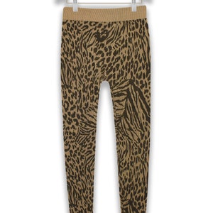 May include: Brown and black animal print leggings. The leggings have a high waist and a stretchy fabric.