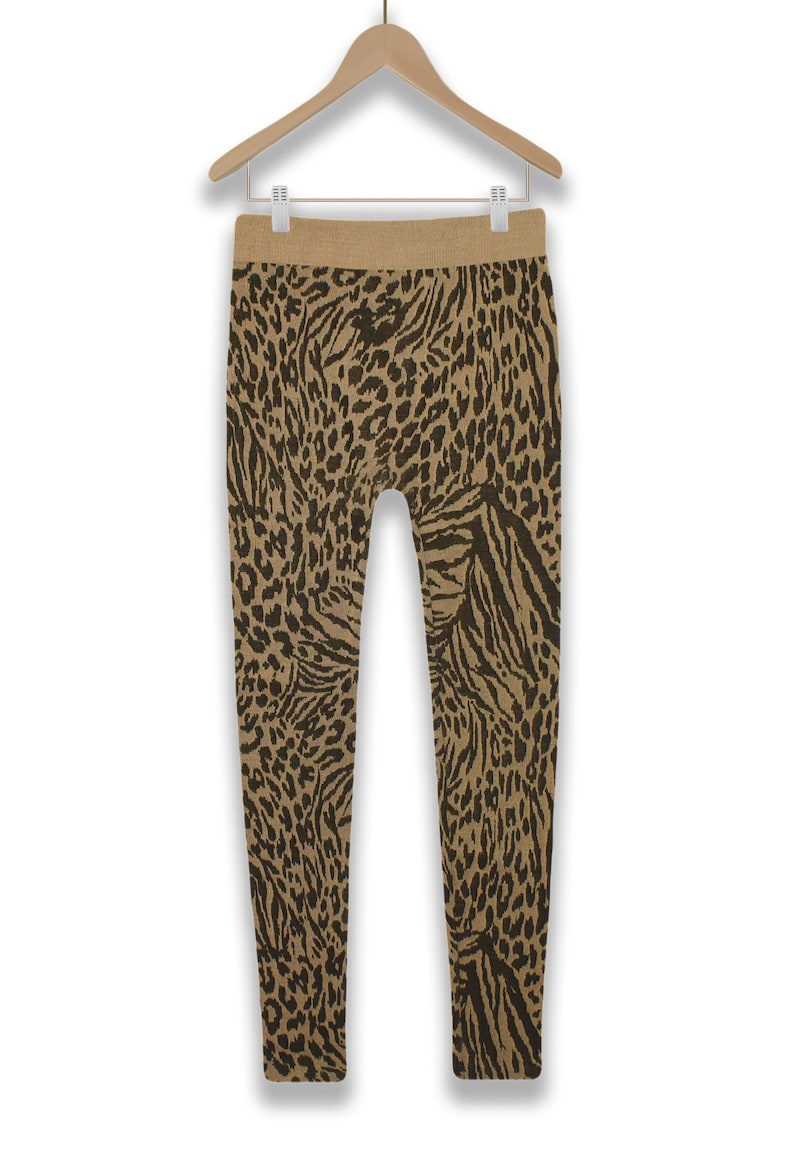 May include: Brown and black animal print leggings. The leggings have a high waist and a stretchy fabric.