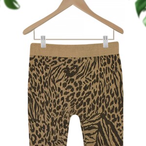May include: Brown and black animal print leggings with a wide waistband.