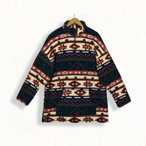 May include: A navy blue fleece pullover with a multi-colored geometric pattern. The pattern includes shades of red, brown, white, and green. The pullover has a zipper closure and a kangaroo pocket.