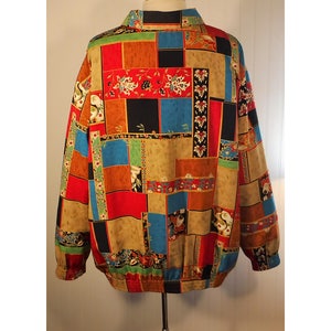 May include: A colorful, patterned jacket with a patchwork design featuring red, blue, green, black, and brown squares. The jacket has a zipper closure and a stand-up collar.
