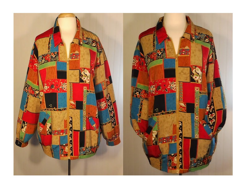 May include: A colorful, patchwork-style jacket with a zipper closure. The jacket features a variety of geometric shapes and floral patterns in shades of red, blue, green, black, and brown.