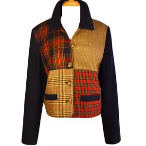 May include: A navy blue blazer with a patchwork design featuring red, green, and yellow plaid patterns. The blazer has a collar, long sleeves, and button closures.