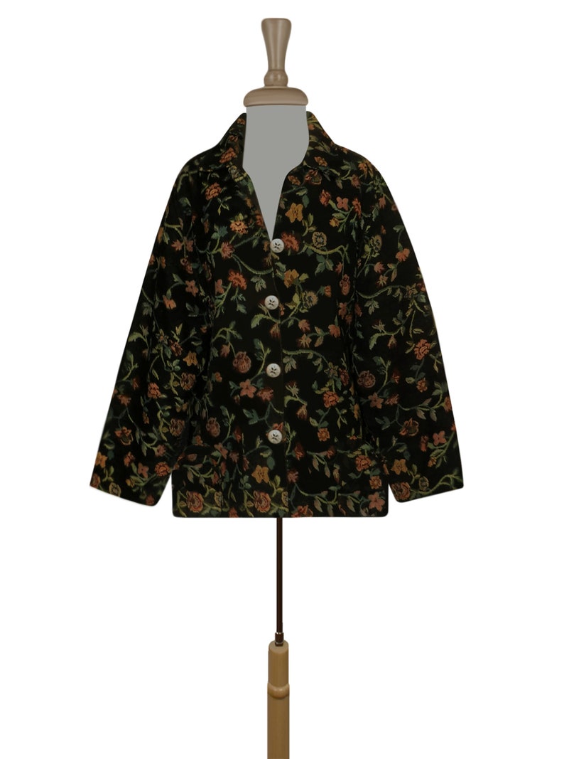 May include: A black floral patterned jacket with a button-up front and long sleeves.