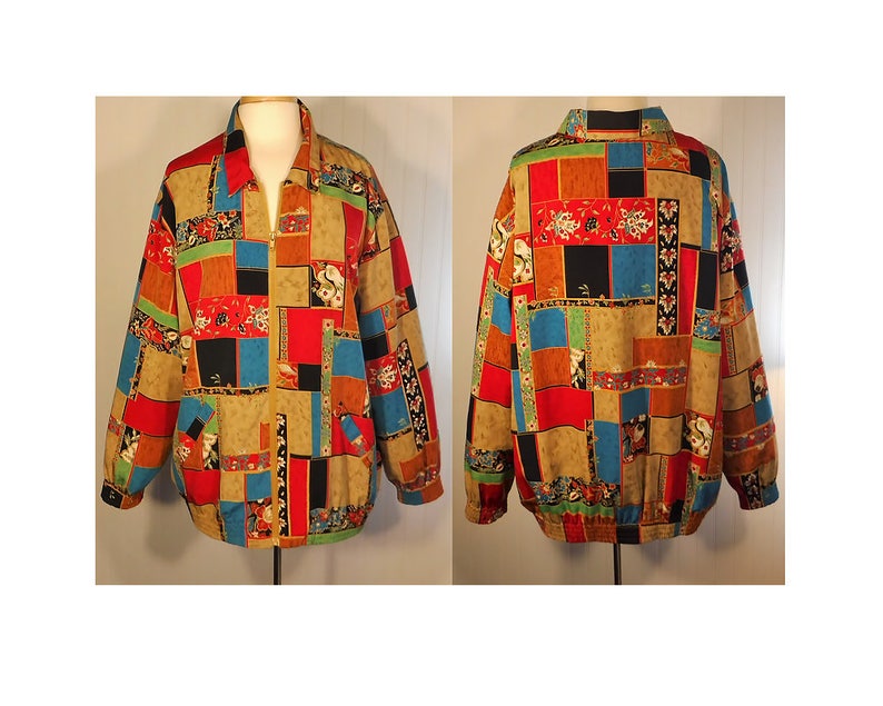May include: A colorful, patterned jacket with a zipper closure. The jacket has a patchwork design with squares of different colors and patterns, including red, blue, green, and yellow. The jacket is made of a lightweight fabric and has a relaxed fit.