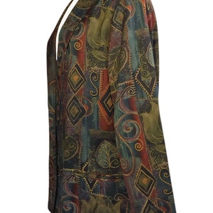 May include: A patterned blazer in shades of green, red, and brown, featuring geometric and floral designs. The jacket has a notched collar and two front pockets. The fabric appears to be a soft, possibly silk, material.