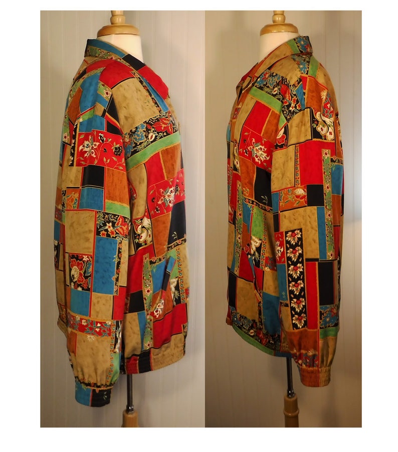 May include: A long-sleeved shirt with a patchwork design featuring various colors and patterns, including red, blue, green, and black. The shirt has a button-up collar and a relaxed fit.