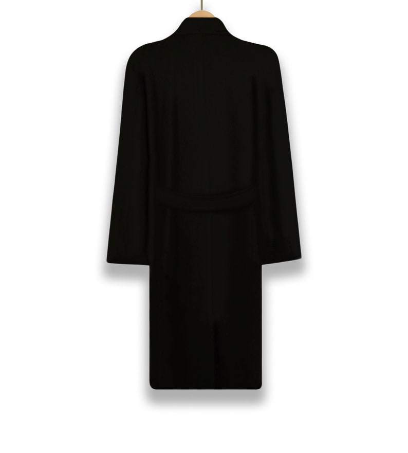 May include: A black long-sleeved coat with a belt and a collar.