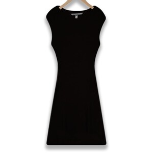 May include: A black sleeveless dress with a scoop neck and a fitted silhouette. The dress has a small tag that reads "Victoria's Secret".