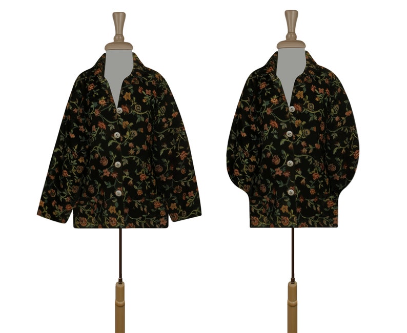 May include: Two black floral patterned jackets on mannequins. The jackets have a button-up front and long sleeves.