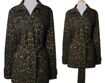 May include: A brown and black leopard print jacket with a belt and pockets. The jacket is buttoned up and has a collar.