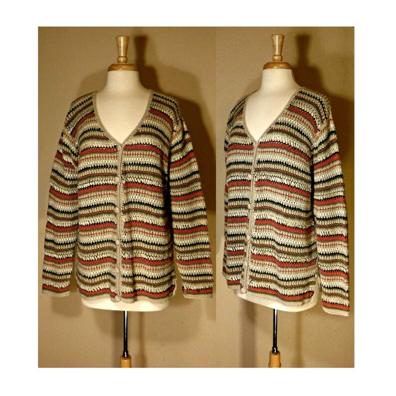 May include: A striped cardigan with a v-neck and button closure. The cardigan is made of a soft, knitted fabric and features a variety of colors, including beige, brown, and red.