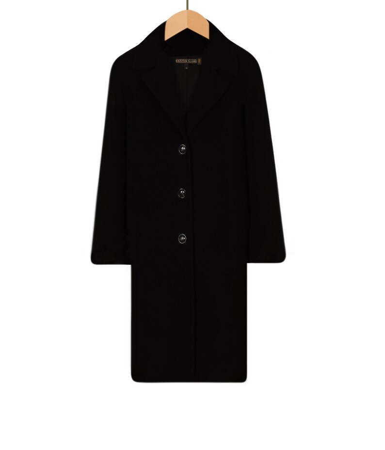 May include: A black long-sleeved coat with a collar and four buttons down the front.