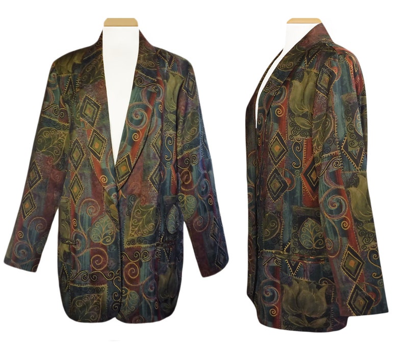 May include: A patterned blazer with a colorful design. The jacket features a mix of colors, including green, red, and blue, with a diamond and floral pattern. The blazer has a classic cut with a notched lapel and two front pockets.
