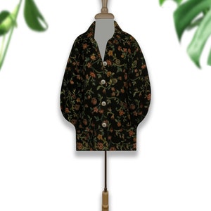 May include: A black button-up shirt with a floral pattern in shades of orange, green, and brown. The shirt is on a mannequin.