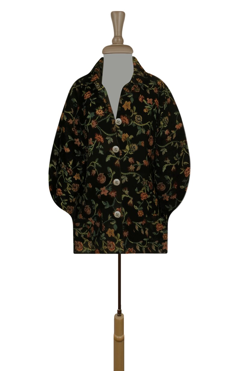 May include: A black floral patterned jacket with a button-up front and long sleeves. The jacket has a slightly puffed sleeve and a relaxed fit.