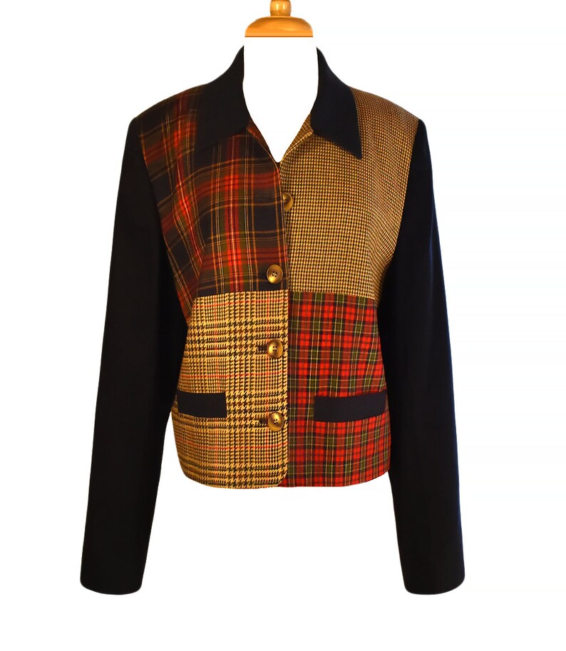May include: A black blazer with a patchwork design featuring different plaid patterns in red, yellow, and blue.