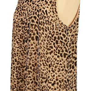 May include: A sleeveless dress with a brown and tan leopard print pattern.