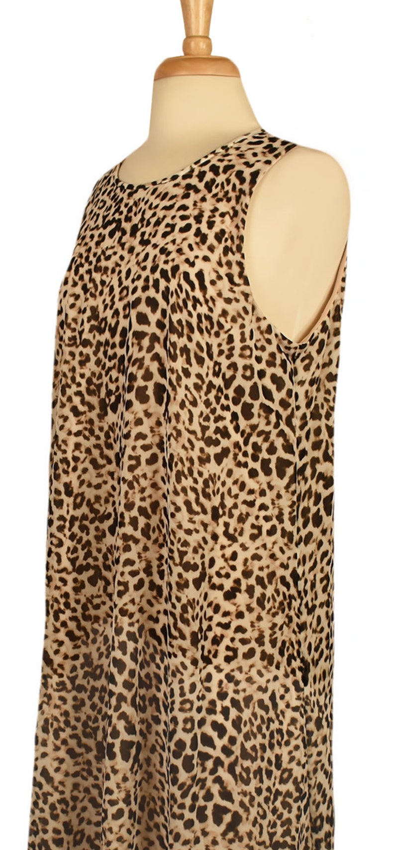 May include: A sleeveless dress with a brown and tan leopard print pattern.